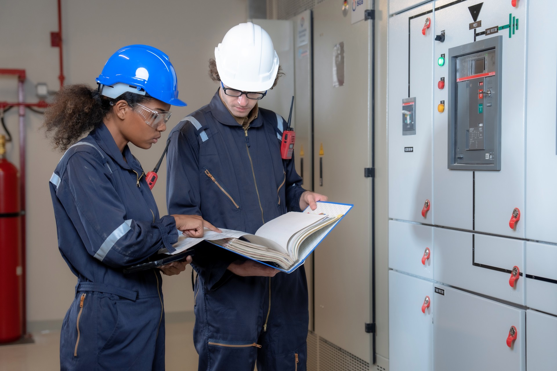 Team of electrical engineers working in front of the HVAC control panel, Check the electrical system in the control for safety.